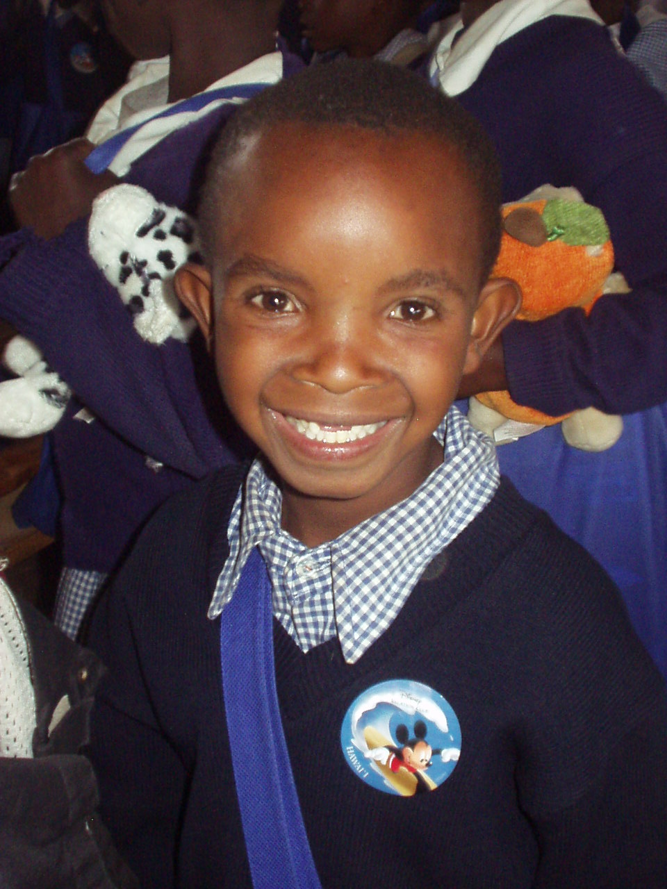 Smiling Kenyan boy after getting school supplies and donations from World Teacher Aid