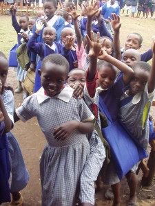 Happy students waiting to see what is inside the donation room with World Teacher Aid