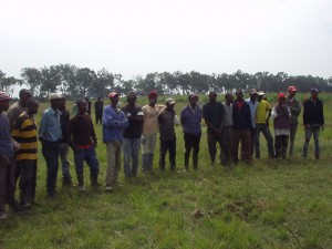 Kenyan Work crew at World Teacher Aid site waiting for kits and Solvay T-shirts