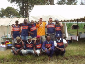 Cooking crew at the Kenya World Teacher Aid school camp site with Solvay Track jersey's
